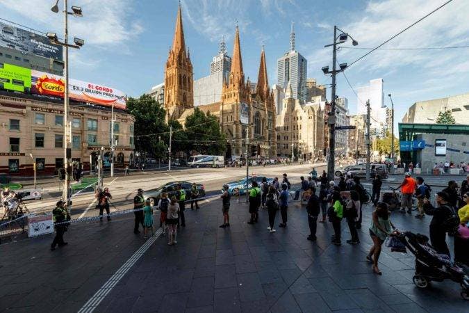 The street outside Flinders Street station is cordoned off by Australian police at the scene where a car ran over pedestrians in downtown Melbourne on December 21, 2017. The car ploughed into a crowd in Australia's second-largest city on December 21 in what police said was a "deliberate act" that left more than a dozen people injured, some of them seriously. / AFP / Mark Peterson