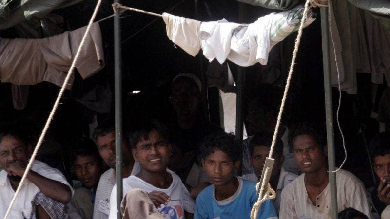 Rohingya refugees sit in their encampment at a military base Friday, Jan. 30, 2009  on Sabang, off the Coast of Banda Aceh, Indonesia.  The Indonesian government is decding what to do with the 193 Rohingyas who were rescued from a decrepit boat found drifting with inadequate supplies by Acehnese fishermen. (AP Photo/Binsar Bakkara)