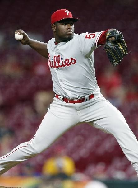 FILE - In this Sept. 3, 2019, file photo, Philadelphia Phillies relief pitcher Hector Neris throws against the Cincinnati Reds during the ninth inning of a baseball game in Cincinnati. Neris avoided a salary arbitration hearing with the Phillies by agreeing to a $4.6 million, one-year contract. The deal reached Thursday night, Feb. 20, 2020,  includes a $7 million team option for 2021 with no buyout. (AP Photo/Gary Landers, File)