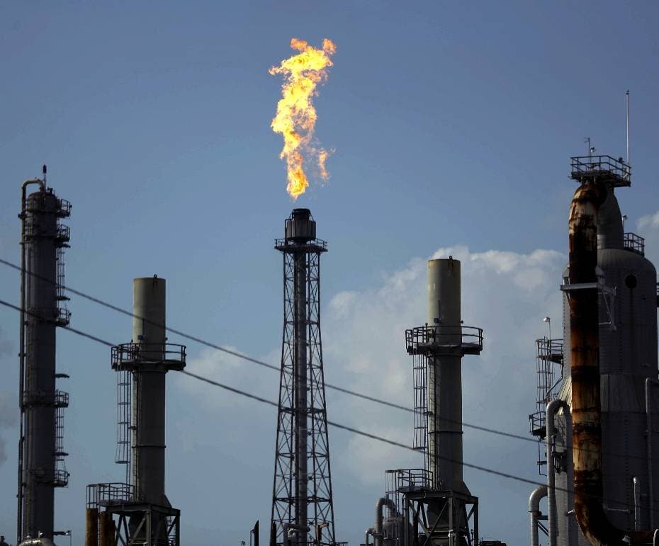 FILE - In this Thursday, Aug. 31, 2017, file photo, a flame burns at the Shell Deer Park oil refinery in Deer Park, Texas. Oil prices are plunging Sunday, March 8, 2020, amid worries that an OPEC dispute will lead a virus-weakened economy to be awash in an oversupply of crude. (AP Photo/Gregory Bull, File)