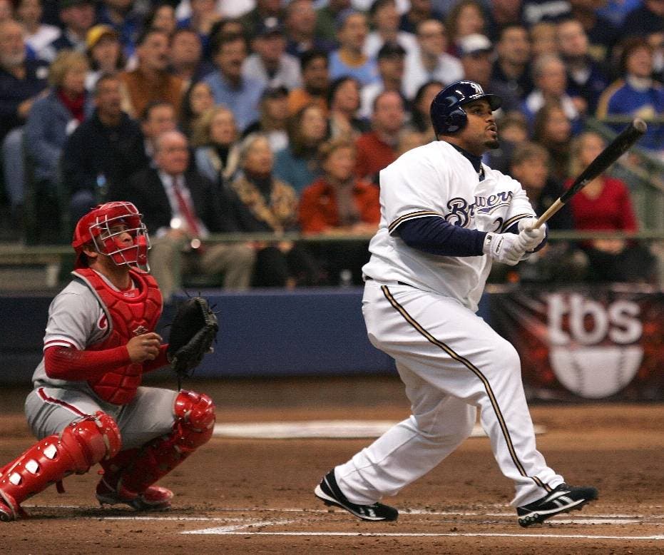 Prince Fielder (R) of the Milwaukee Brewers hits a sacrifice fly to drive in Mike Cameron in the bottom of the second inning against the Philadelphia Phillies in Game three of the NLDS during the 2008 MLB playoffs at Miller Park on October 4, 2008 in Milwaukee, Wisconsin.      AFP PHOTO/Jim McIsaac/Getty Images  == FOR NEWSPAPERS, INTERNET, TELCOS & TELEVISION USE ONLY ==