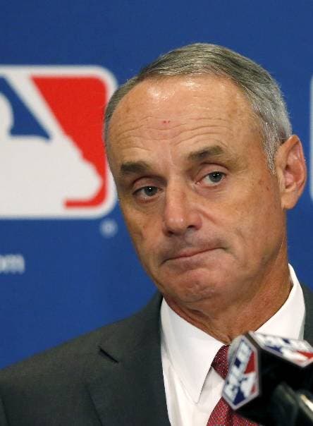 FILE - In this Aug. 17, 2017, file photo, Commissioner Rob Manfred listens to a question following the two-day meeting of Major League Baseball owners, Thursday, Aug. 17, 2017, in Chicago. With Japanese star Shohei Otani considering a jump to an MLB team, Manfred said he believes it will be hard for teams to circumvent existing contract rules in pursuit of the coveted two-way player. (AP Photo/Charles Rex Arbogast, File)