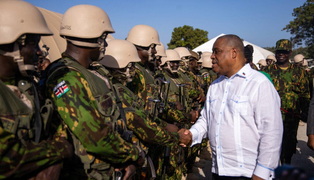 Haiti Kenya Haitian Prime Minister Garry Conille shakes hands with Kenyan police at their base in Port au Prince AP24178535536506 A2