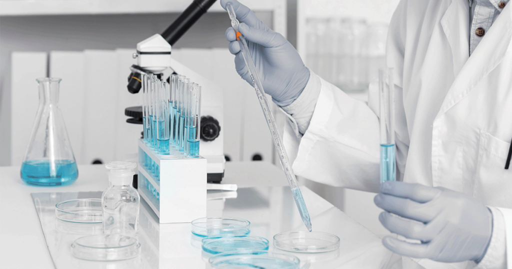 man in lab working with microscope